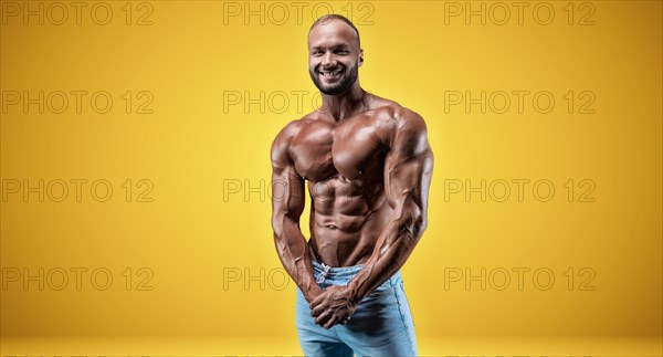 Isolated professional sportsman on a yellow background. Bodybuilding concept. Panorama. Advertising of a gym and sports nutrition.