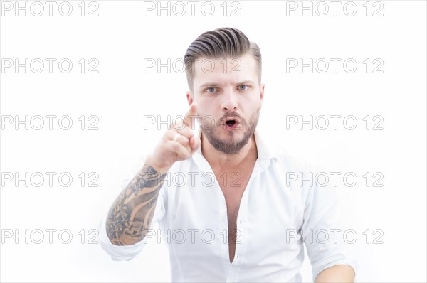 Bearded stylish man shows a finger at the camera. The concept of a harsh boss.