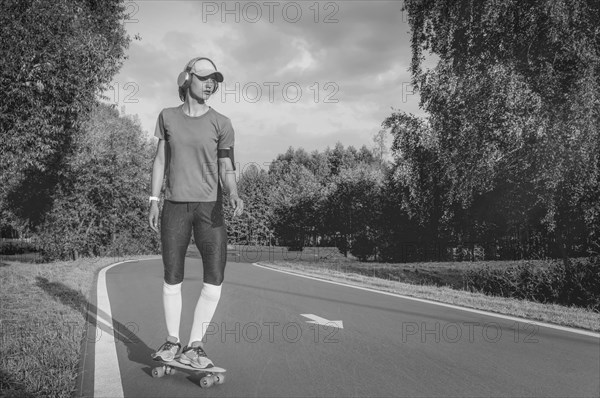 Image of a girl riding a skateboard in the park. Sports concept.