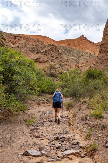 Climber in a canyon with a dry stream bed