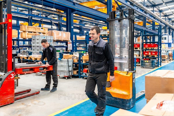 Male handling workers in a modern logistic factory on duty