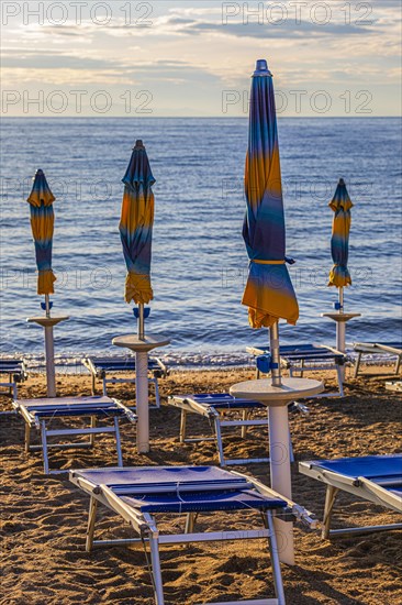 Sun loungers and parasols on Straccolignino beach at sunrise, near Capoliveri, Elba, Tuscan Archipelago, Tuscany, Italy, Europe