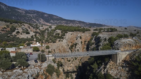 Metal bridge over a gorge with parked cars and mountain backdrop, Aradena Gorge, Aradena, Sfakia, Crete, Greece, Europe