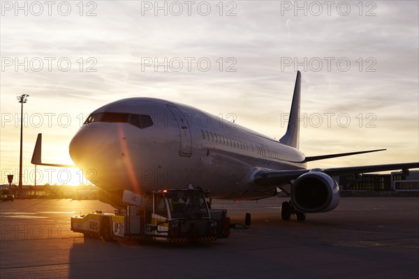 Airbus aircraft towing with push back vehicle in the sunset, Munich Airport, Upper Bavaria, Bavaria, Germany, Europe