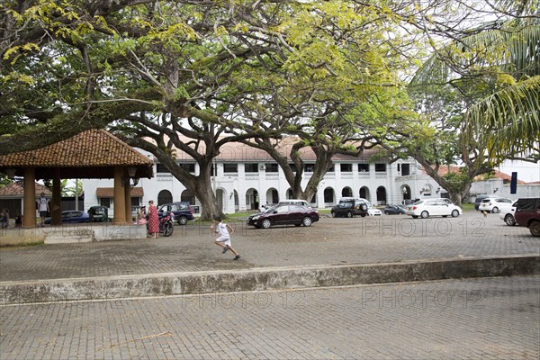 Child running across historic Court Square in the town of Galle, Sri Lanka, Asia