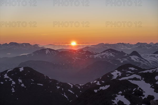 Sunset behind the mountains, mountain panorama with remnants of snow from the summit of Skala, Loen, Norway, Europe