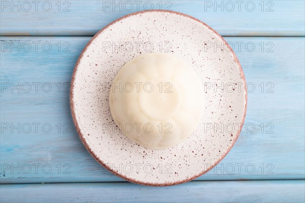 White milk jelly on blue wooden background. top view, flat lay, close up