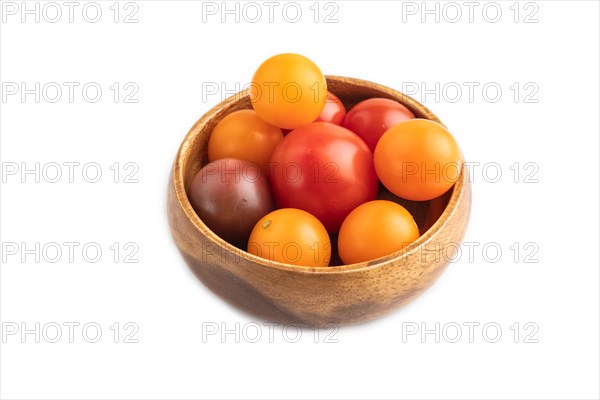 Red. yellow cherry tomatoes in wooden bowl isolated on white background. Side view