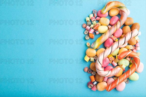 Various caramel candies on blue pastel background. copy space, top view, flat lay