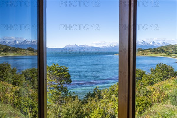 Reflection in a window: View across the Beagle Channel to the mountains of Hoste Island Chile, Ushuaia, Tierra del Fuego Island, Patagonia, Argentina, South America