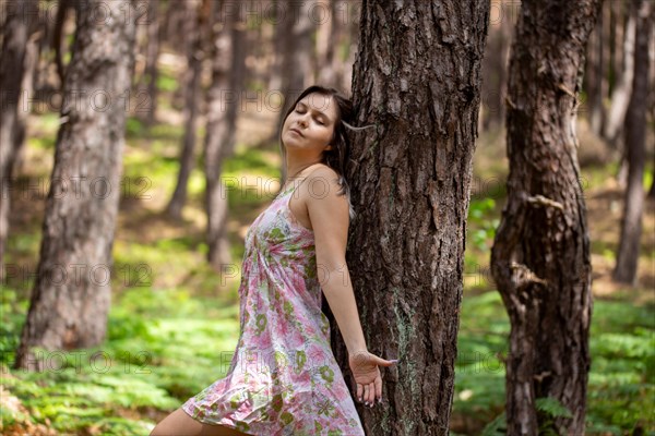 Young woman bathing in the forest (Shinrin Yoku), nature therapy from Japan