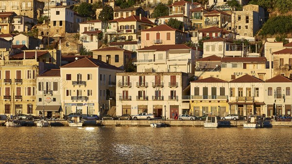 Houses and boats on the coast in the golden light of early morning, Gythio, Mani, Peloponnese, Greece, Europe