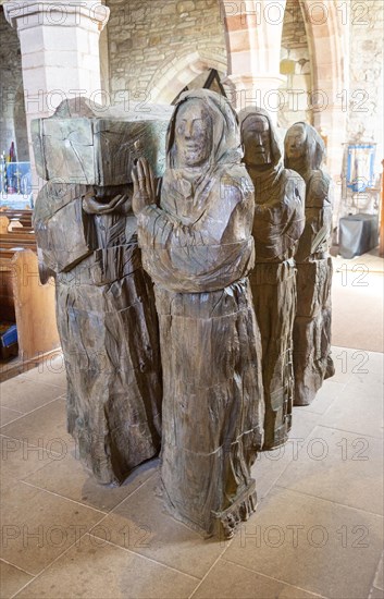 The Journey Sculpture of monks carrying body of Saint Cuthbert by Fenwick Lawson 1999 Holy Island, Northumberland, England, UK