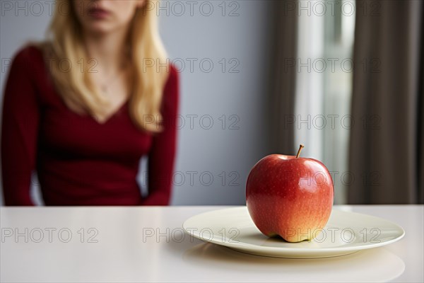 Plate with single apple fruit on plate with blurry woman in background. Dieting concpet. KI generiert, generiert AI generated