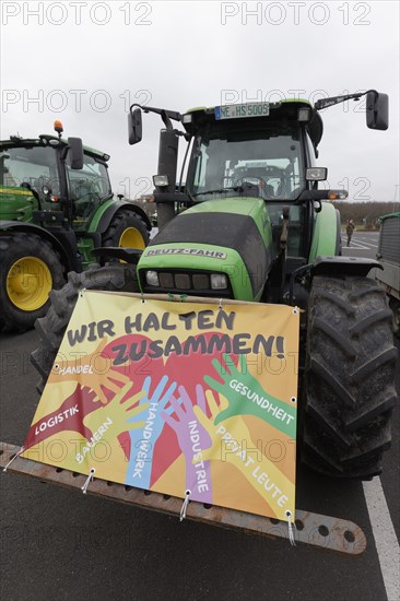 We stick together, sign on a tractor, farmers' protests, demonstration against policies of the traffic light government, abolition of agricultural diesel subsidies, Duesseldorf, North Rhine-Westphalia, Germany, Europe