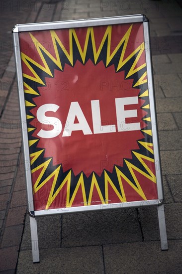 Close up of street shop Sale poster standing on pavement