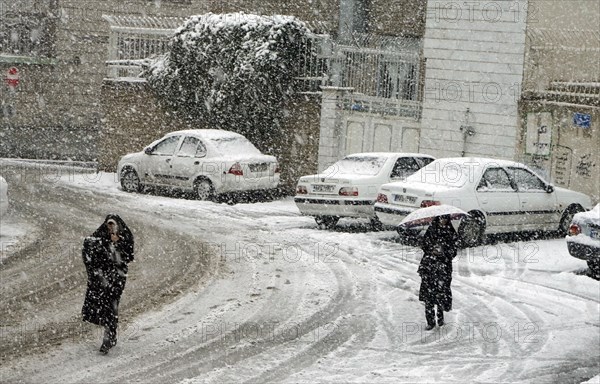 Heavy snowfall in Arak, Iran, woman with chador and traditional clothing, 16/03/2019, Asia