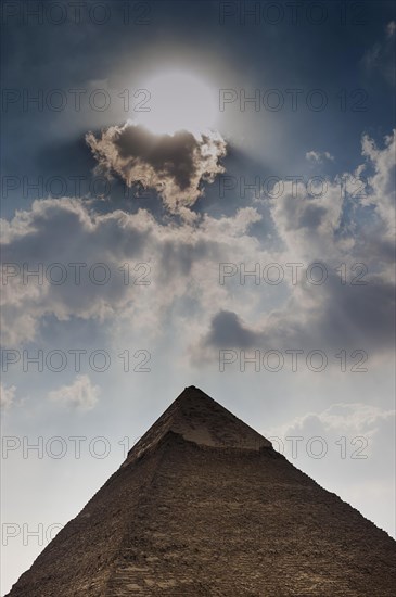 Pyramid of Giza in dramatic sunlight, cloud, sky, gloomy, dramatic, sunbeam, desert, wonder of the world, building, Cheops pyramid, architecture, building, antique, history, history of the earth, history of mankind, monument, world history, epoch, kingdom, pharaoh, tomb, tomb site, Cairo, Egypt, Africa