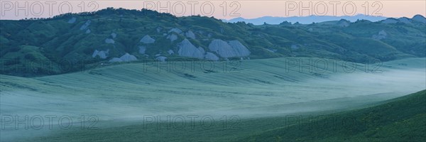 Early morning fog shortly in front of sunrise in the Crete Senesi, Province of Siena, Tuscany, Italy, Europe