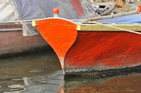 Detail of a colourful boat by the water with striking red paintwork, Varanasi, Uttar Pradesh, India, Asia