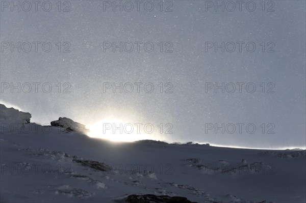 Mountains in Andalusia, mountain range with snow, near Pico del Veleta, 3392m, Gueejar-Sierra, Sierra Nevada National Park, sunrise behind a snow-covered mountain peak with sparkling ice crystals in the air, Costa del Sol, Andalusia, Spain, Europe