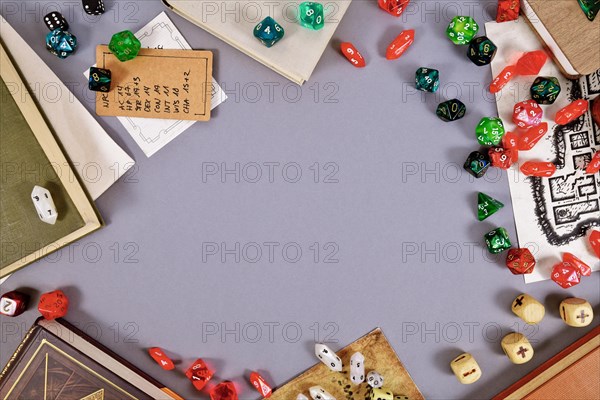 Tabletop role playing flat lay background with RPG dices, rule books, dungeon map and copy space in middle