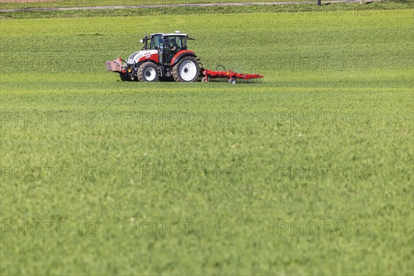 Farmer fertilising his field with a tractor, Neidlingen, Baden-Wuerttemberg, Germany, Europe