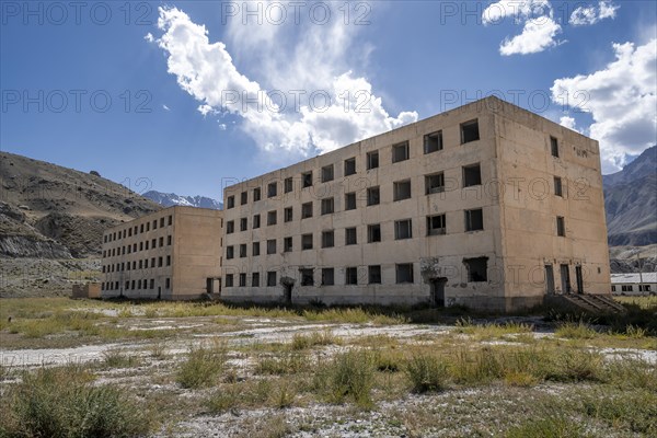 Abandoned, destroyed residential buildings, old Soviet apartment blocks in the ghost town, Engilchek, Tian Shan, Kyrgyzstan, Asia