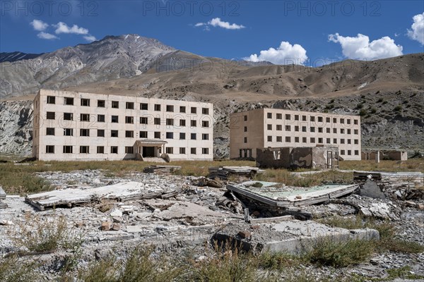 Abandoned, destroyed residential buildings, old Soviet apartment blocks in the ghost town, Engilchek, Tian Shan, Kyrgyzstan, Asia