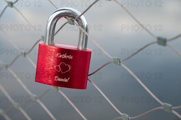 A love lock on the railing of the bicycle and pedestrian bridge over the Danube in Deggendorf, Bavaria, Germany, Europe