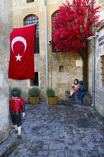 Doll mannequins and Turkish flag in a narrow street, Gaziantep, Turkey, Asia