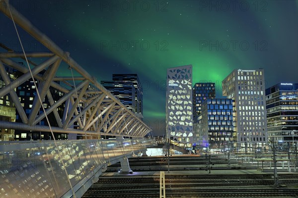 Barcode neighbourhood with acrobats pedestrian bridge night Northern Lights Oslo Norway