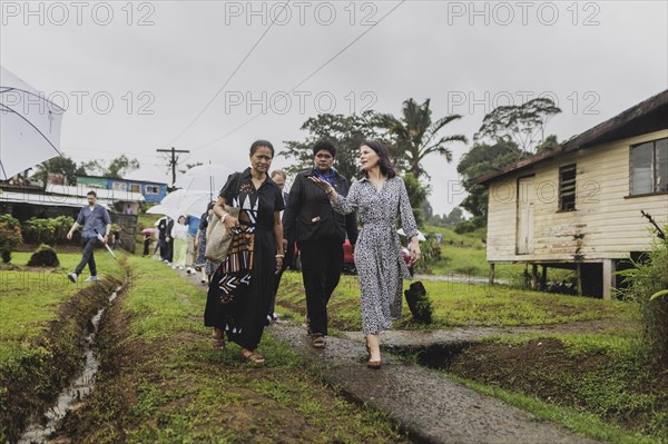 (R-L) Annalena Baerbock (Buendnis 90/Die Gruenen), Federal Foreign Minister, and Christine Fung, employee of the Deutsche Gesellschaft fuer Internationale Zusammenarbeit, photographed during a visit to the village of Vuniniudrovo, 6 May 2024. Baerbock is travelling to Australia, New Zealand and Fiji for political talks / Photographed on behalf of the Federal Foreign Office