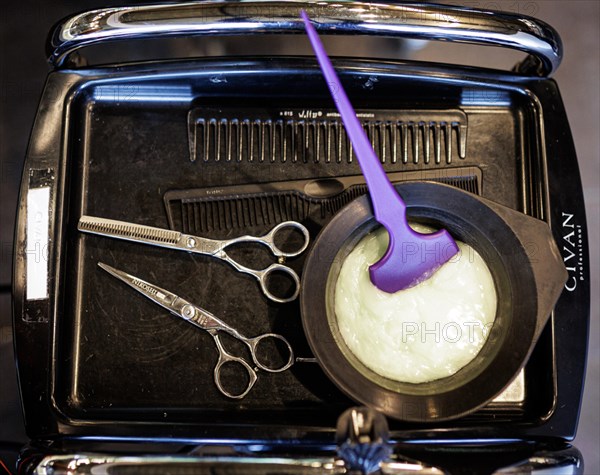 Tray of a hairdresser with mixed hair colour, scissors and comb, taken in the hairdressing salon Coiffeur Sivan in Berlin, 22.04.2024