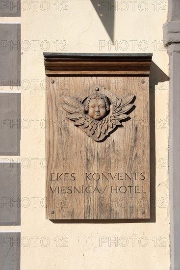 Lettering Ekes Konvent on a wooden sign, was a convent for impoverished widows and fallen girls in the Middle Ages, today a hotel, Riga, Latvia, Europe