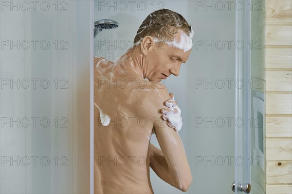 Middle-aged man takes morning shower