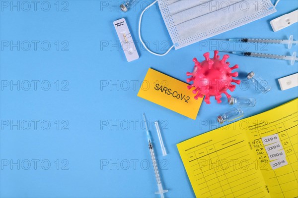 Corona Virus flatlay with vaccine passport, serums, vials and tests