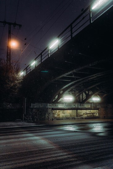 Snow-covered railway bridge, subway in Koblenz, Germany. Taken at night with long exposure