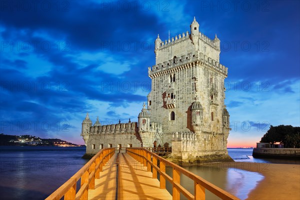 Belem Tower or Tower of St Vincent, famous tourist landmark of Lisboa and tourism attraction, on the bank of the Tagus River (Tejo) after sunset in dusk twilight with dramatic sky. Lisbon, Portugal, Europe