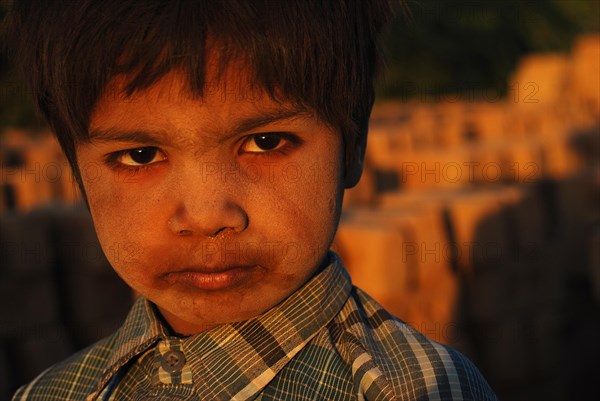 Boy working in a brick kiln, Kutch district, Gujarat, India, Asia