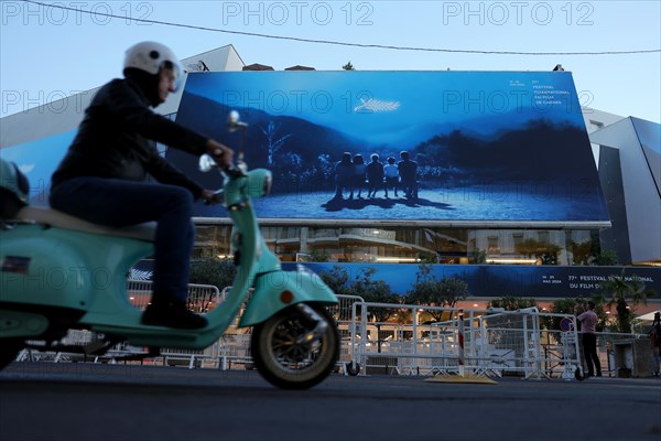 Cannes, France, 13 May 2024: A moped rides in front of the Palais des Festivals et des Congres on the eve of the opening of the festival. The 77th Cannes International Film Festival will take place from 14 to 25 May 2024, Europe