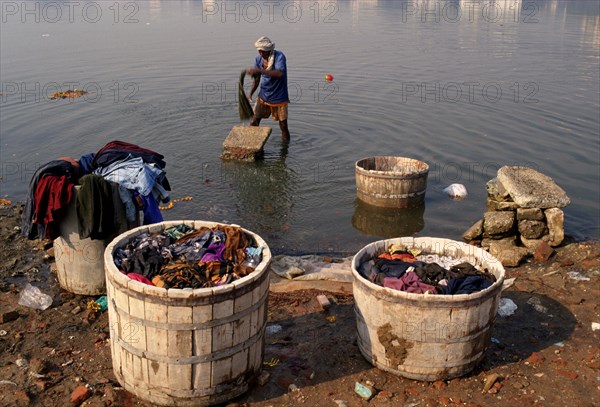 Man washing clothes in the Sabarmati river, Ahmedabad, Gujarat, India, Asia