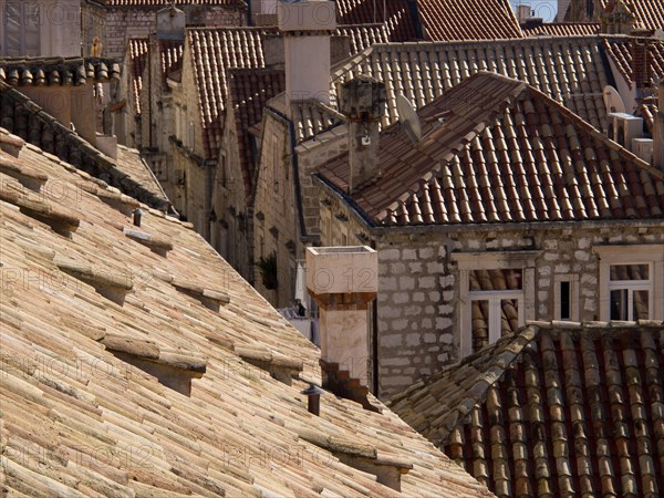 View of the closely spaced terracotta roofs of the historic city, the old town of Dubrovnik with historic houses, churches, red roofs and fortress walls, dubrovnik, coratia