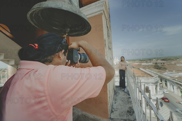 Tourists taking photographs at the viewpoint of the La Merced church, Granada. Tourist couple taking pictures at the viewpoint of the La Merced church