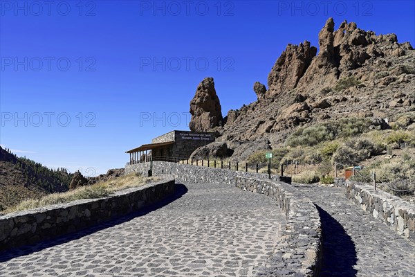 On the way to Mount Teide, El Teide, Pico del Teide, volcano in the Teide National Park on Tenerife, Canary Islands, Spain, Europe, Stone building of the Museo Juan Evora with impressive rock formations in the background and a paved path, Tenerife, Europe