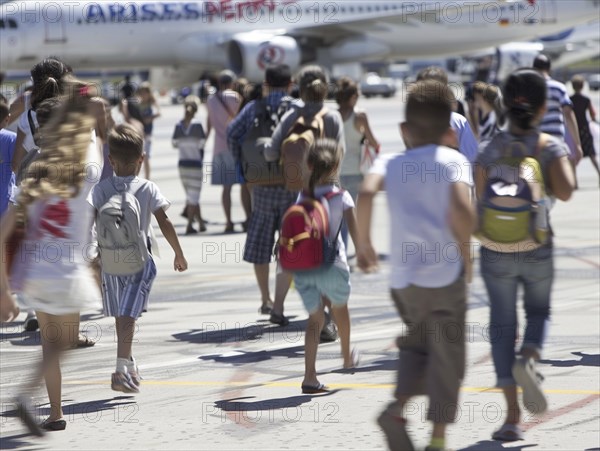 Passengers wait to board their plane at the airport, AI generated