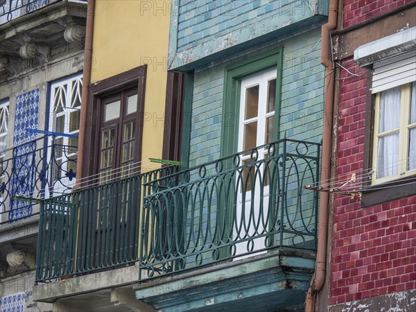 Facades of houses with colourful balconies, clotheslines and windows, old houses in the old town of Porto on the Douro, Porto, portugal