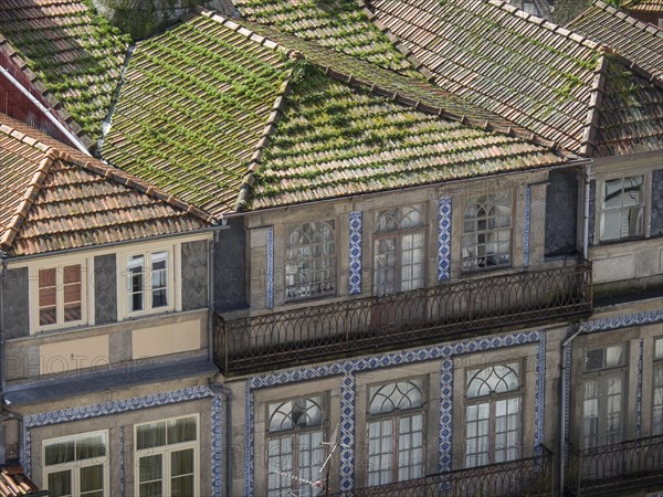 Historic buildings with green tiled roofs and decorative tiles create a harmonious and nostalgic atmosphere, old town with historic houses and red roofs in poertugal, porto, portugal