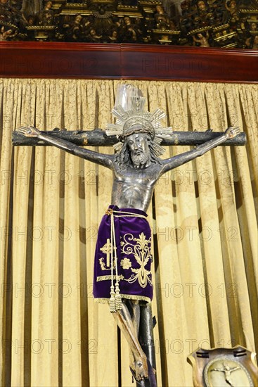 Interior view, La Catedral de la Santa Creu i Santa Eulalia, Barri Gotic, Barcelona, Catalonia, Spain, Europe, A crucifix of Jesus Christ in front of a heavy, folded curtain in a church, Europe