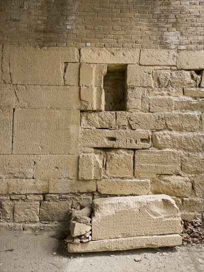 View of sandstone blocks at the bottom of the floor on the left of the wall Sandstone blocks with written chiselled laws carved into the wall of the archway behind the amphitheatre City law of Gortys carved in stone Gortyn law book Large inscription, written in Doric dialect alternately from left to right and right to left, oldest discovered legal text in Europe, Gortyna, Crete, Greece, Europe